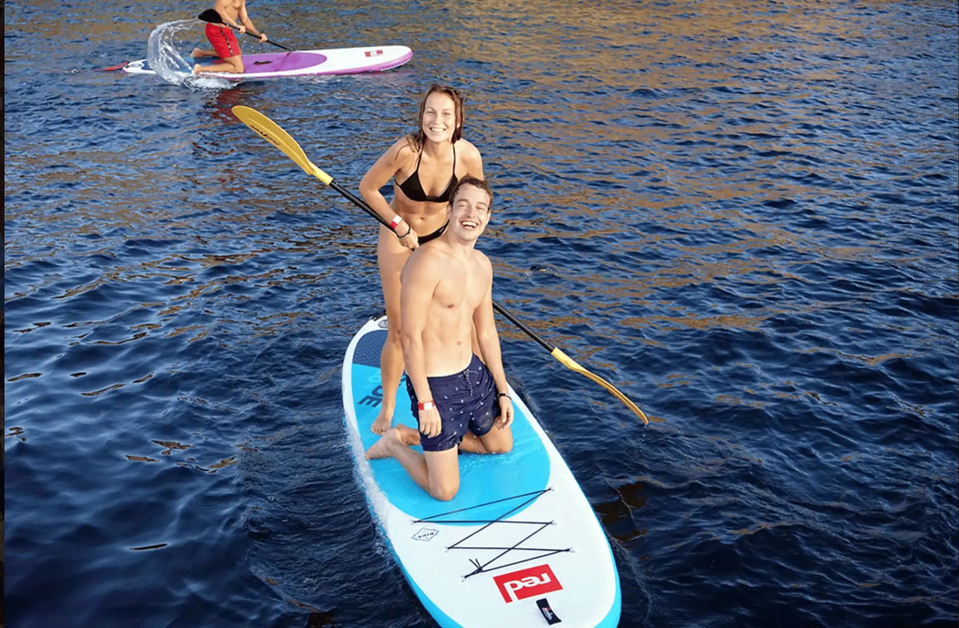 Couple paddleboarding next to Salvador Ibiza