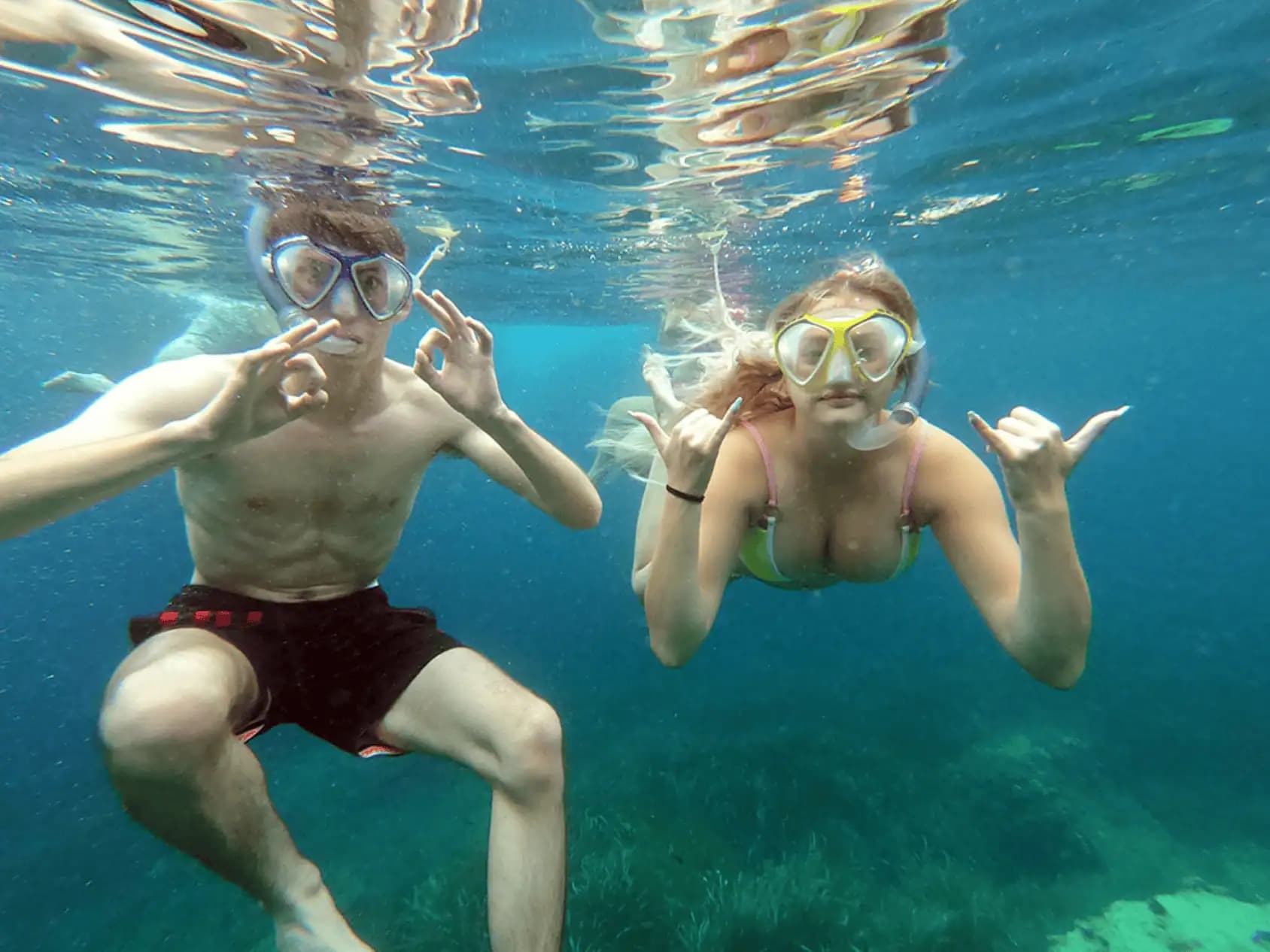 Couple snorkeling in crystal clear waters
