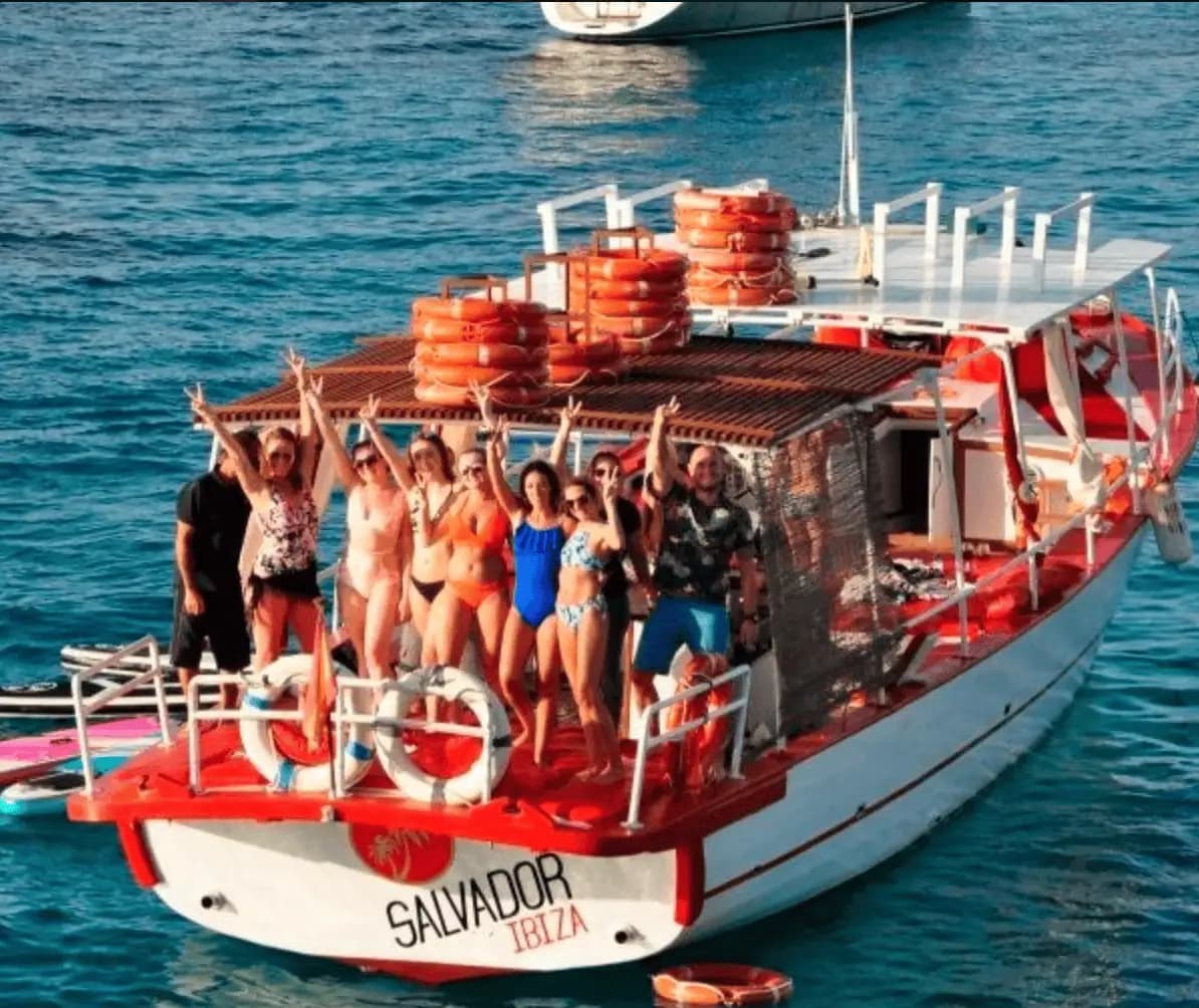 Aerial view of the boat with friends relaxing on the stern