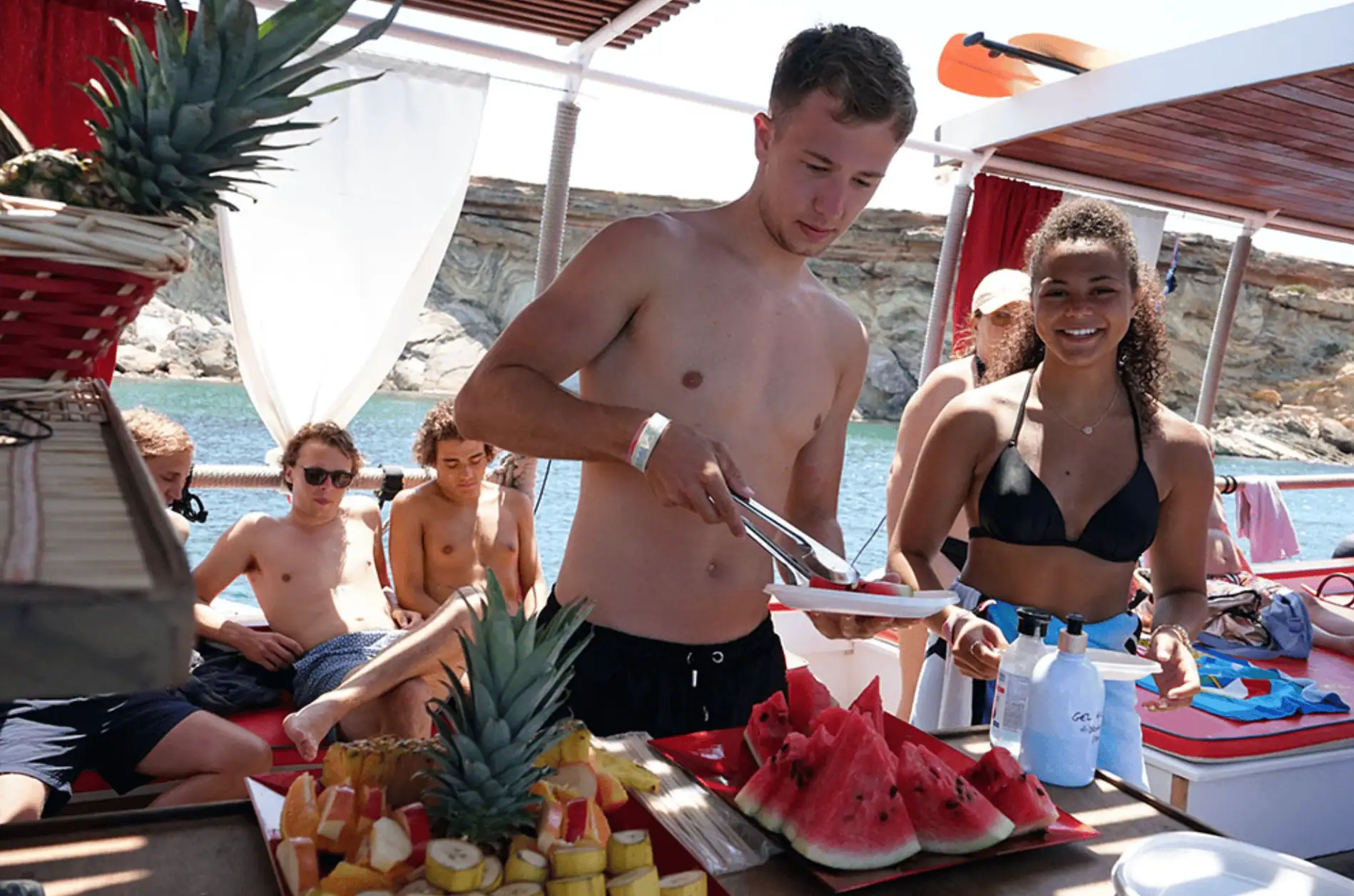 Guest helping themselves to fresh fruit from the onboard bar